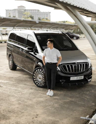 a man standing next to a mercedes benz benz benz benz benz benz benz benz benz