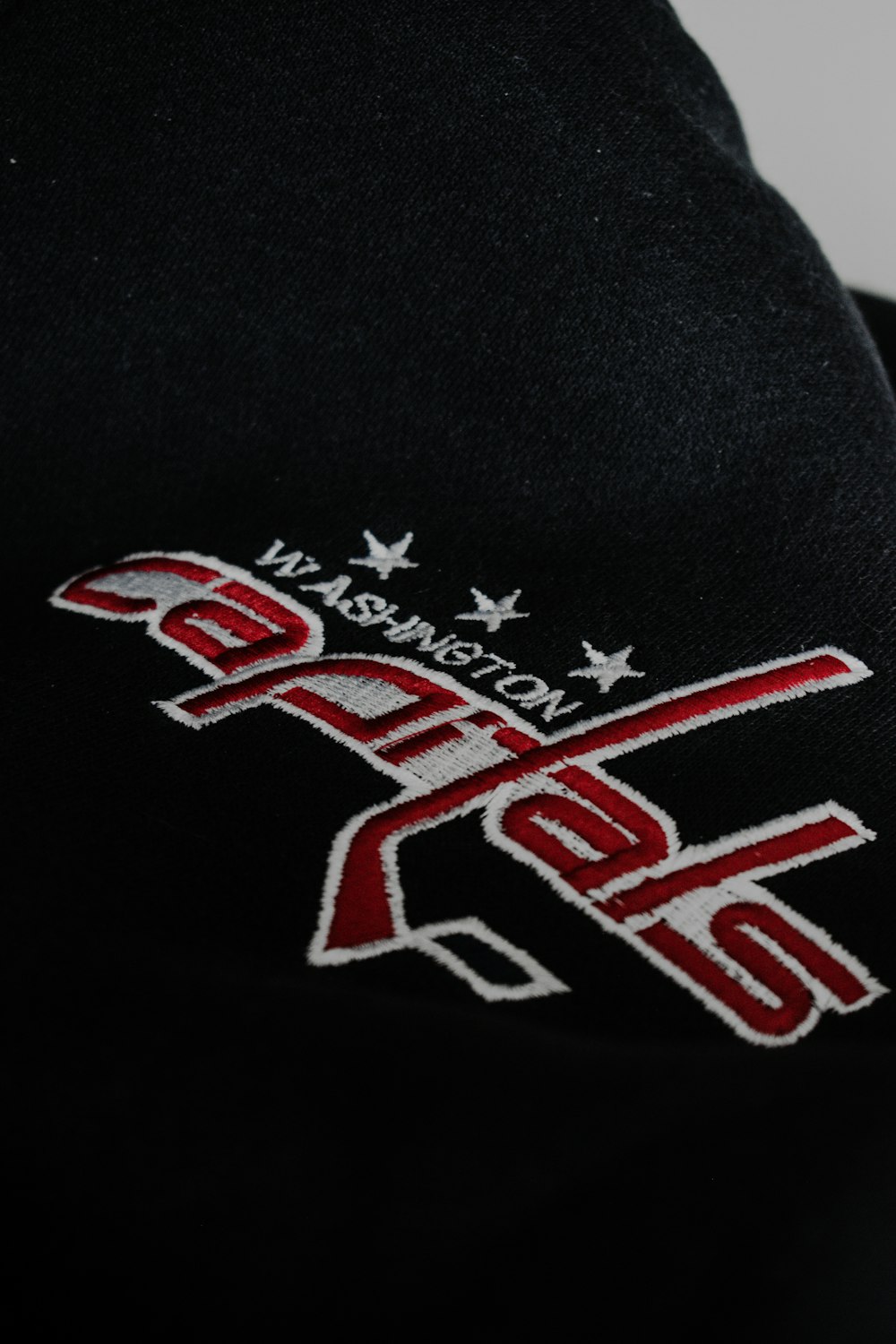 a black hat with a red and white logo on it