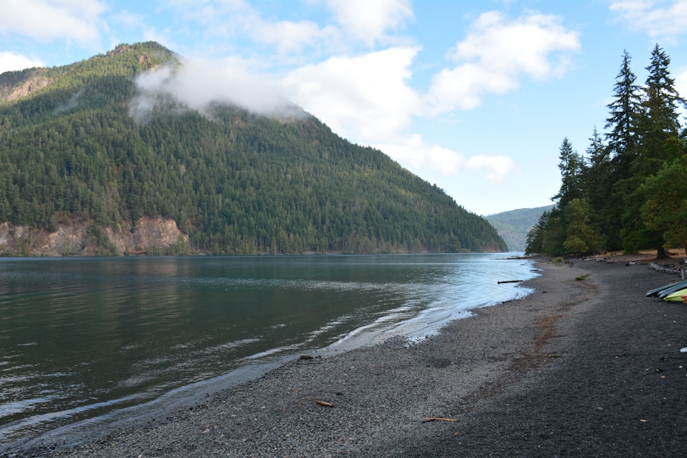 a body of water with a mountain in the background