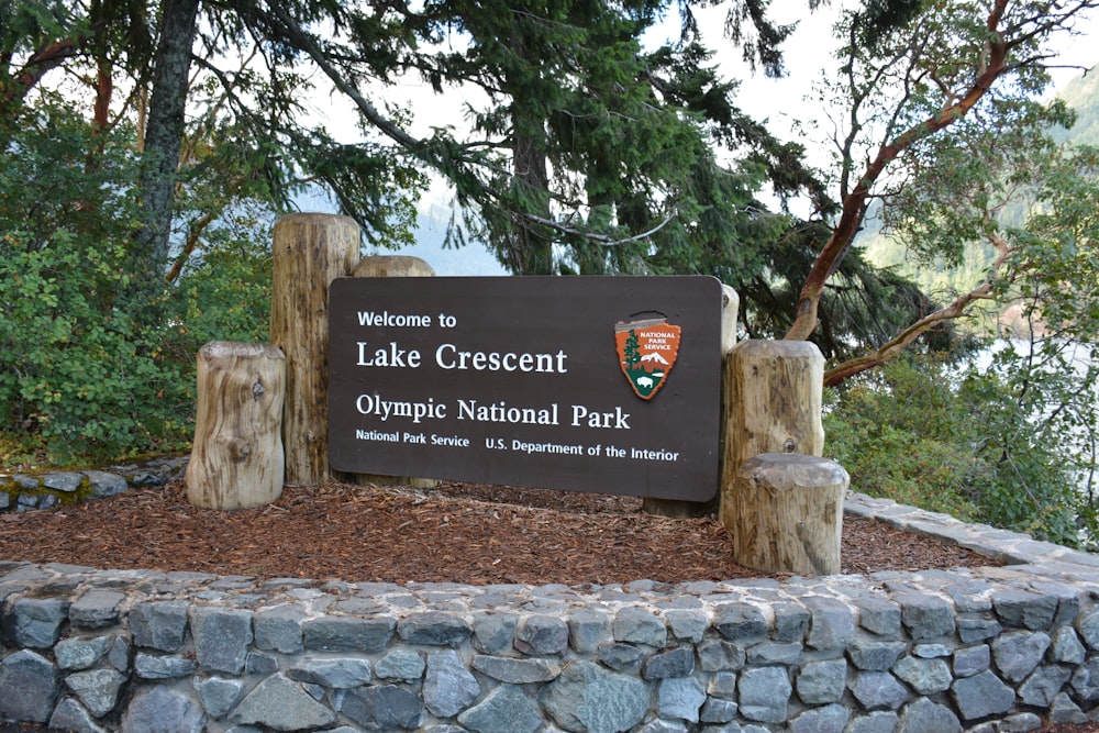 a sign in front of a large rock