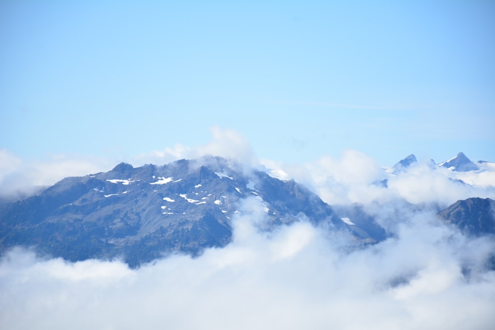 a view of a mountain covered in clouds