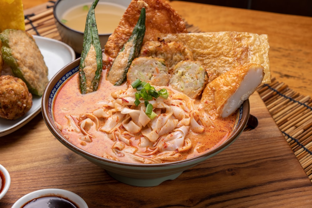 a wooden table topped with bowls of food