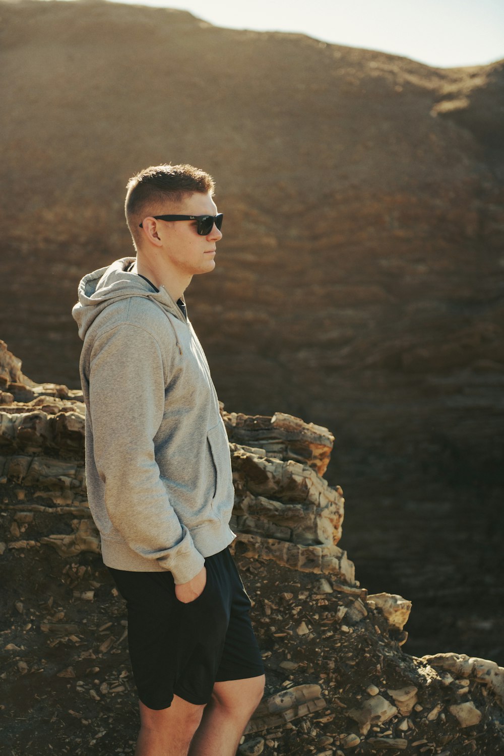 a man standing on top of a rocky hillside