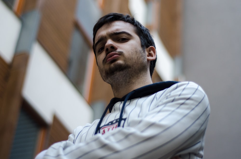 a man standing in front of a tall building