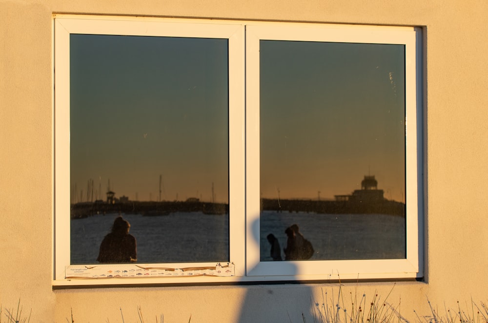 a couple of people are looking out of a window