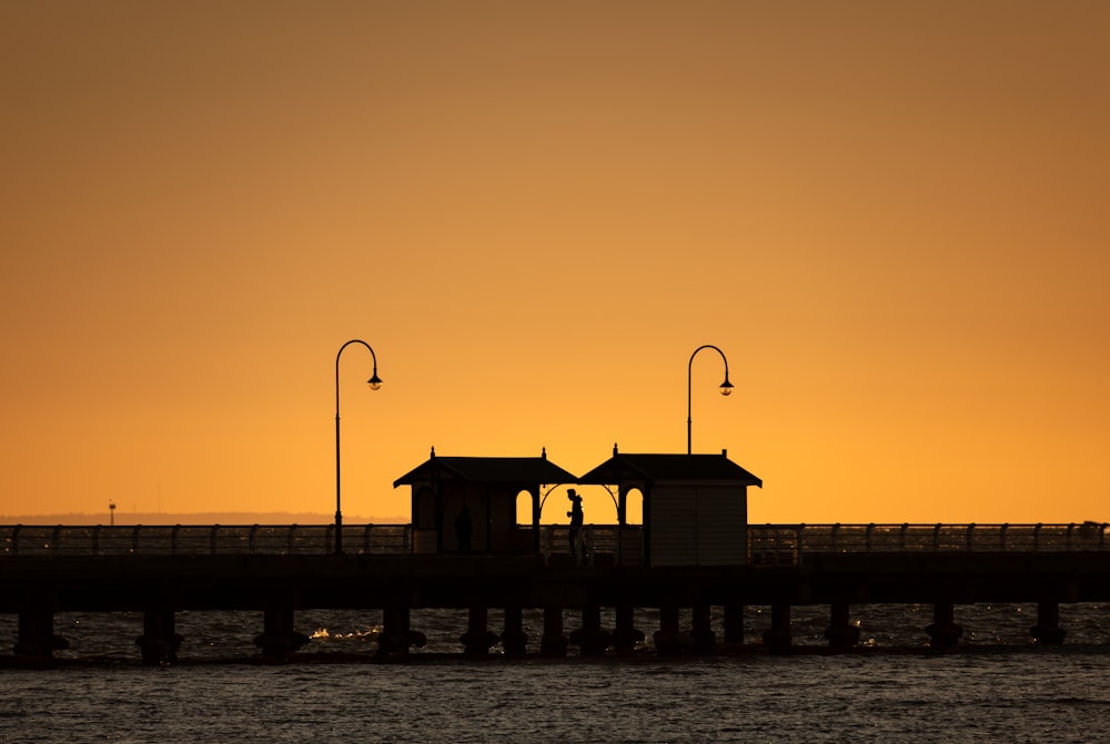 a couple of small buildings sitting on top of a pier