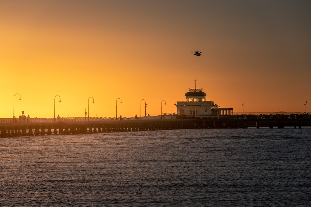 a large body of water with a light house in the distance