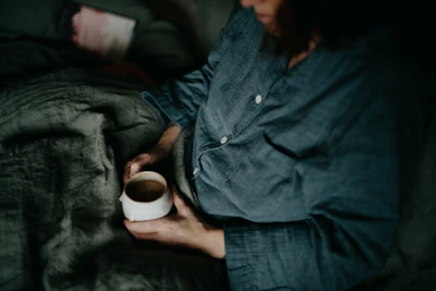a woman is holding a cup of coffee