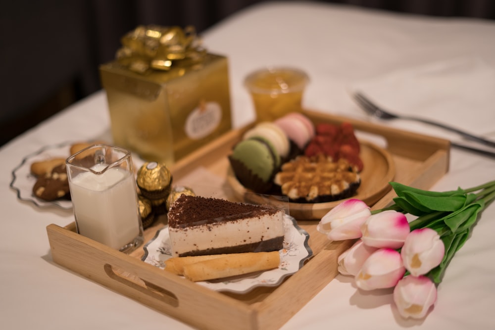 a tray of food on a table with a glass of milk