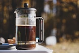 a pitcher of liquid sitting on top of a table