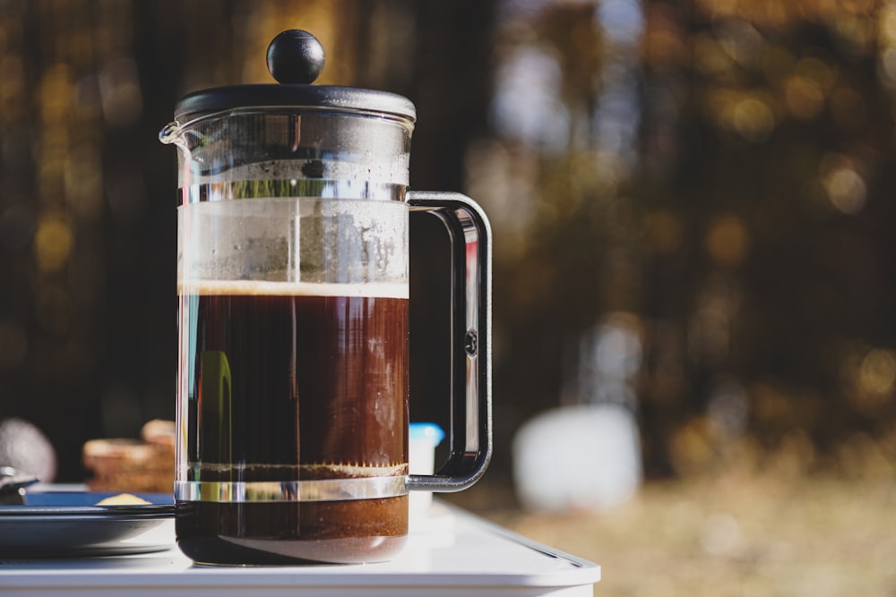 a pitcher of liquid sitting on top of a table