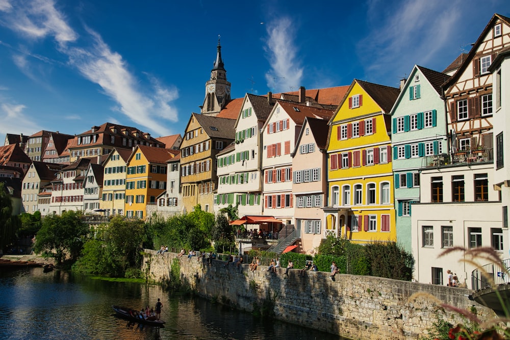 a row of colorful buildings next to a river