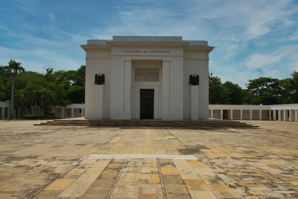 a large white building with a clock on the front of it