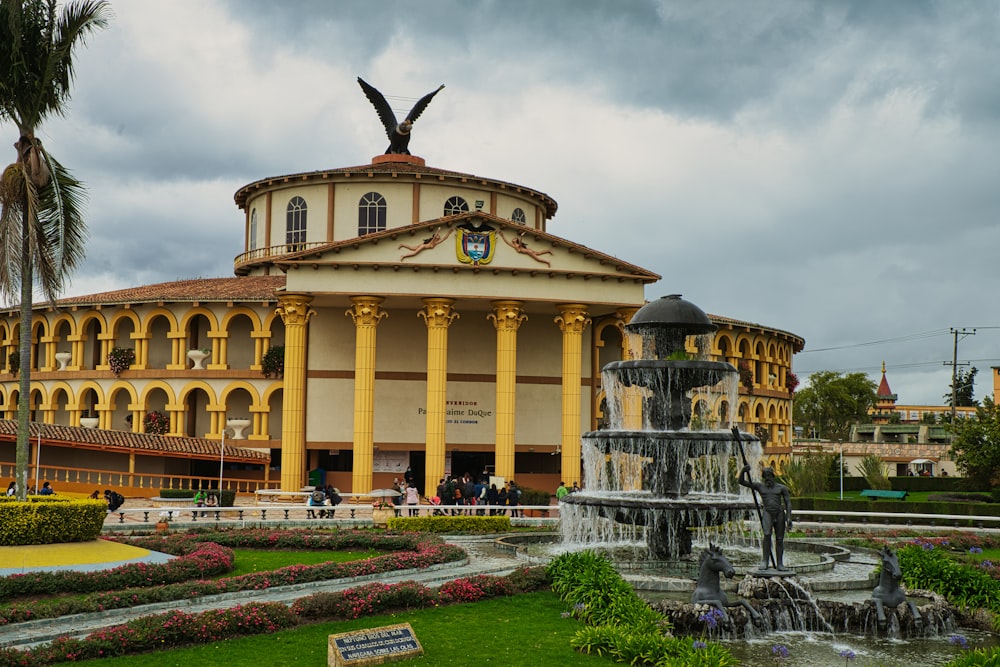 a large building with a fountain in front of it