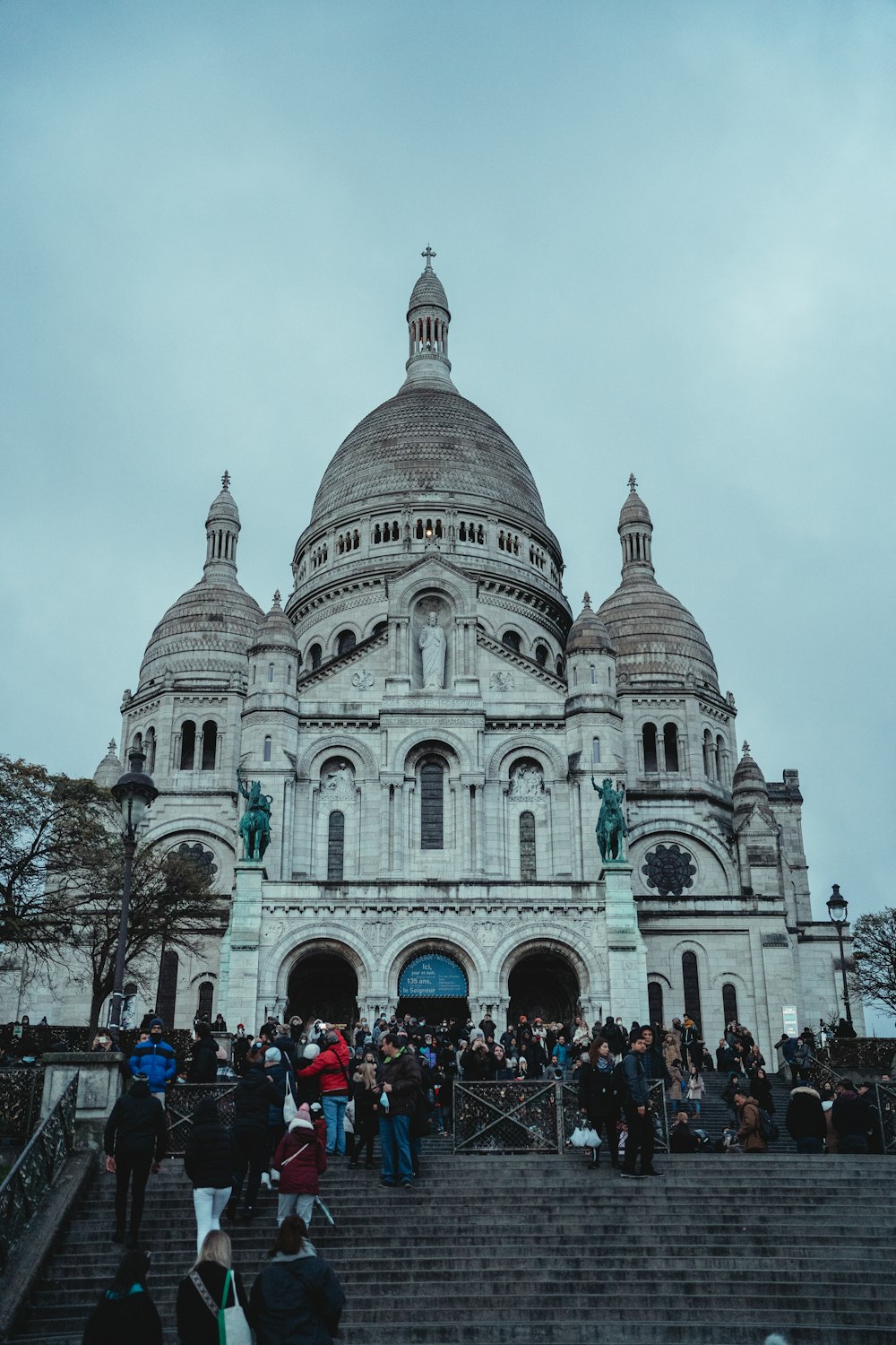 a group of people standing outside of a large building