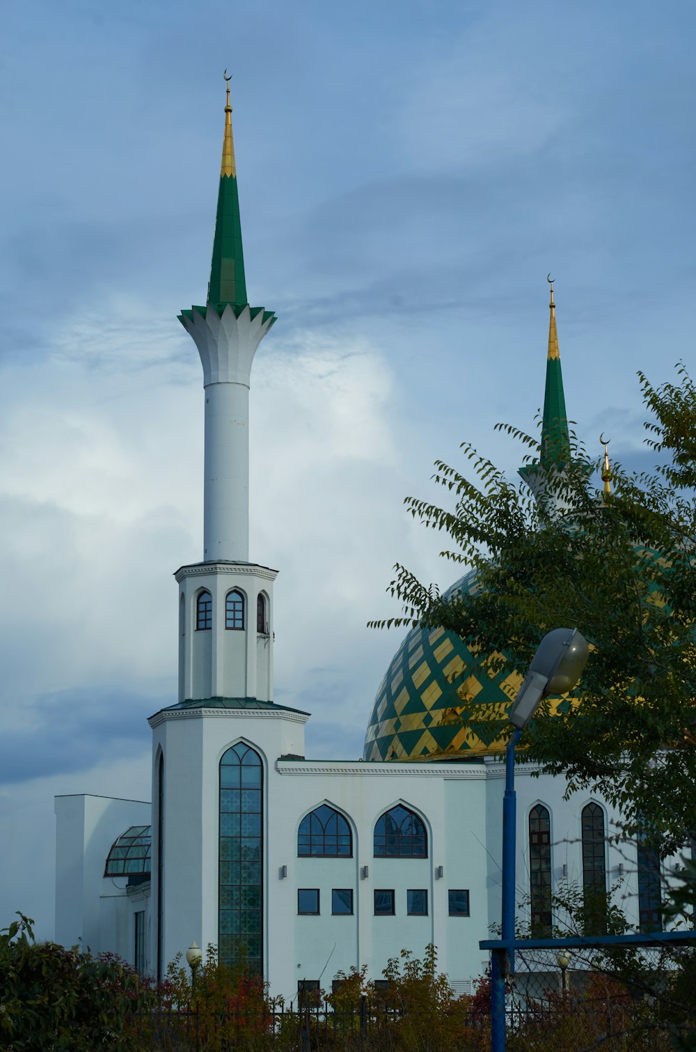 a large white building with a green and yellow roof