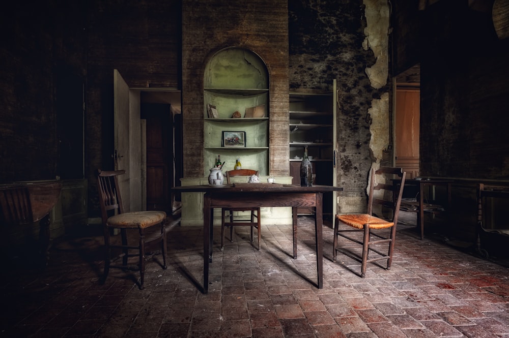 a dark room with a table and two chairs