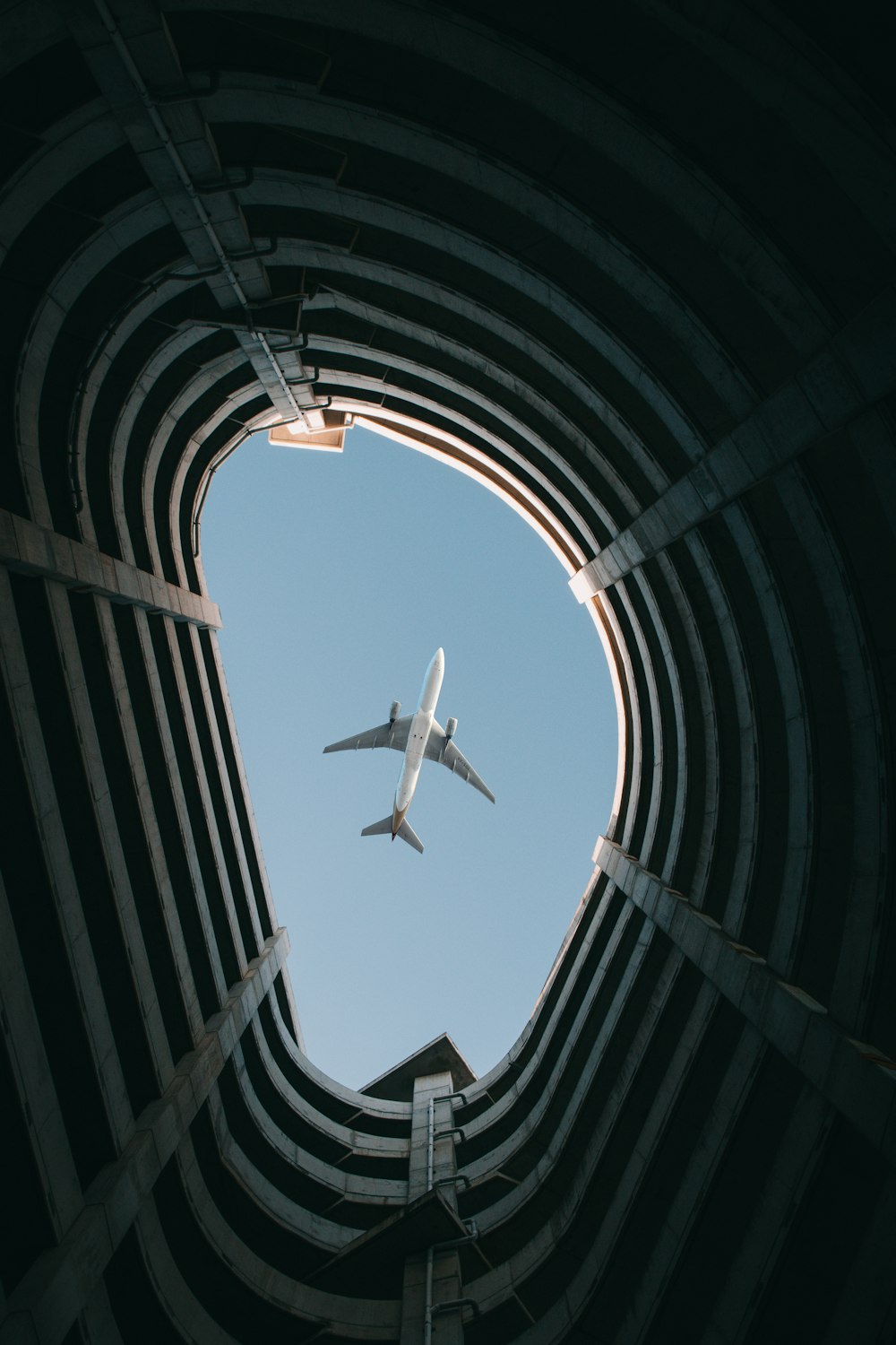 an airplane flying in the sky through a tunnel