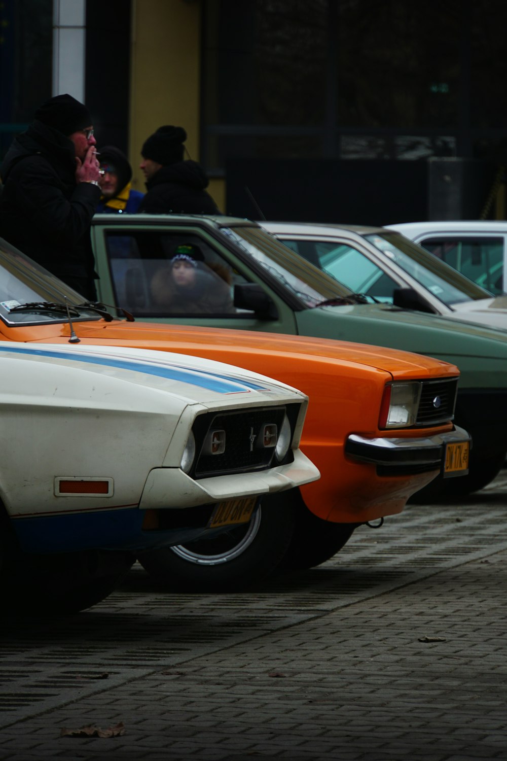 a group of cars parked next to each other on a street