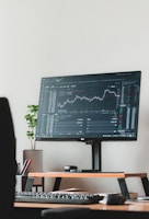 a computer monitor sitting on top of a wooden desk