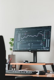 a computer monitor sitting on top of a wooden desk