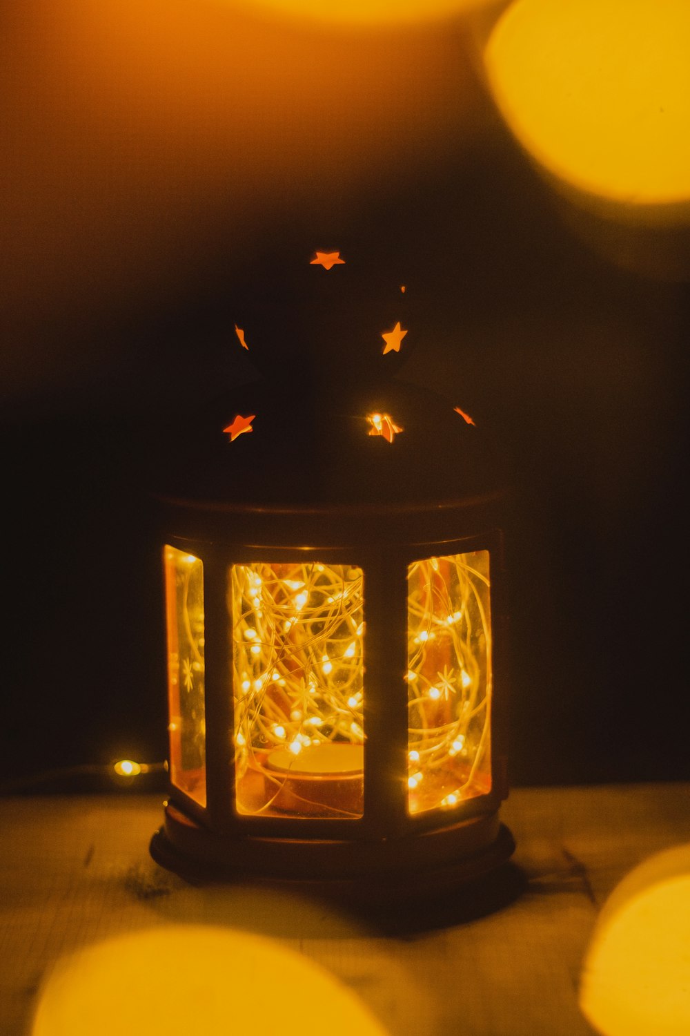 a lantern with a string of lights inside of it