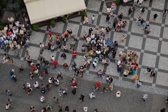 a group of people walking down a street next to each other