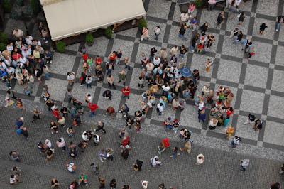 a group of people walking down a street next to each other