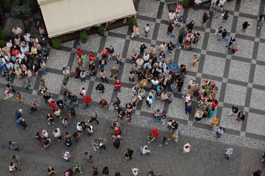 a group of people walking down a street next to each other