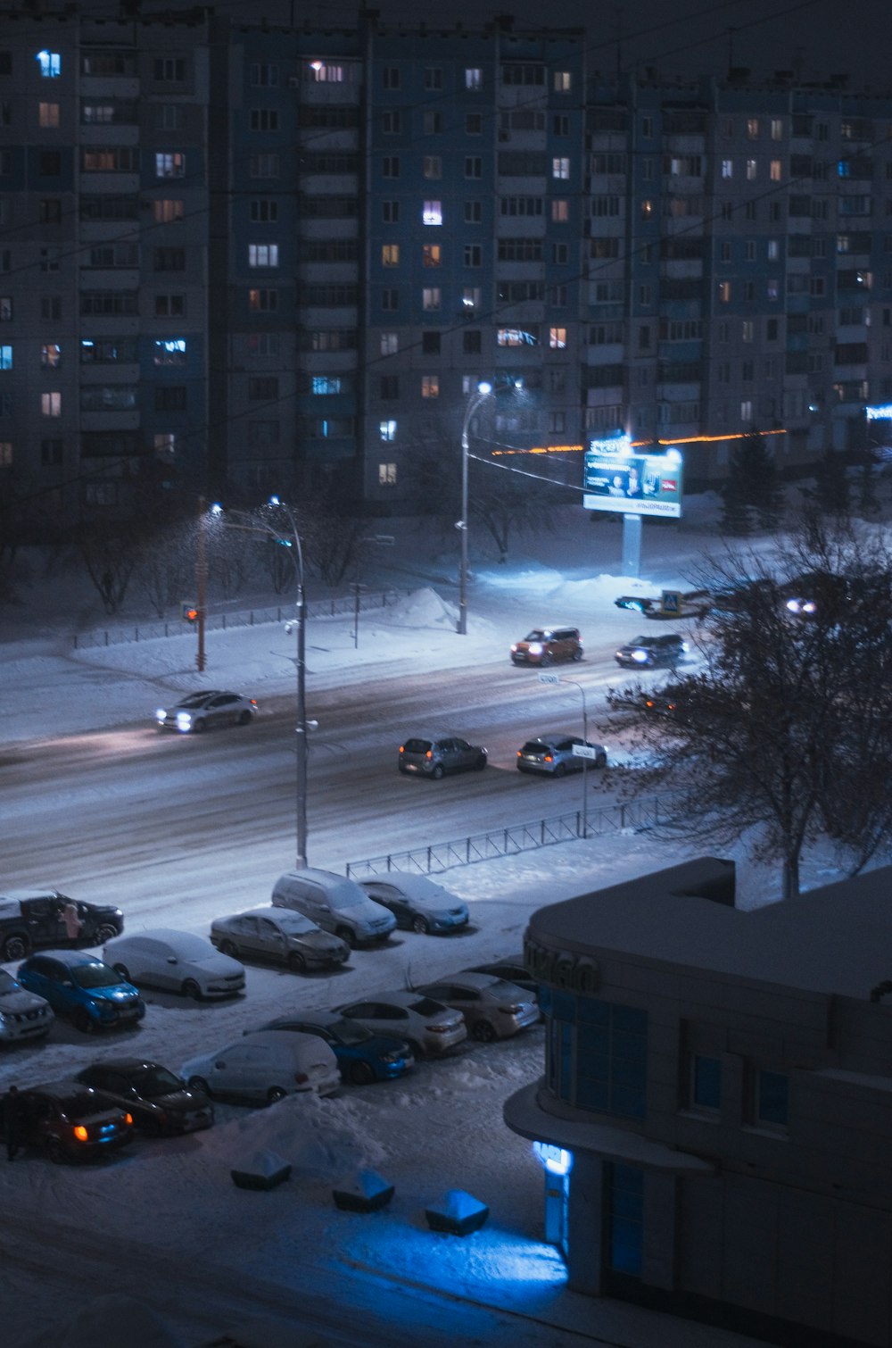 a city street at night covered in snow