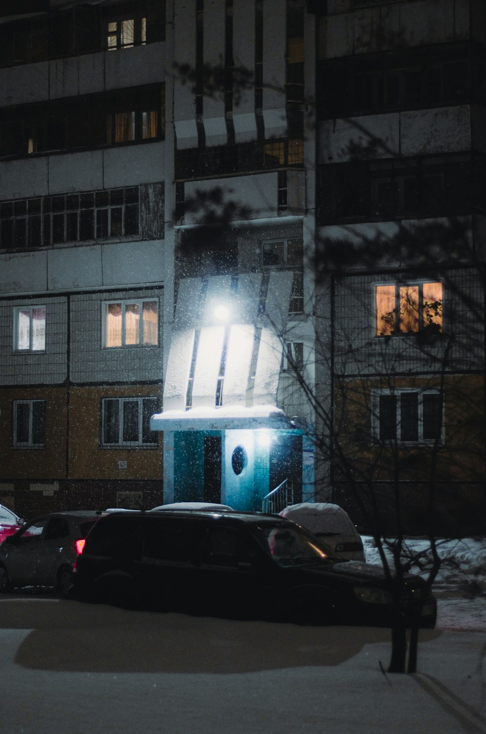 a car parked in front of a building at night