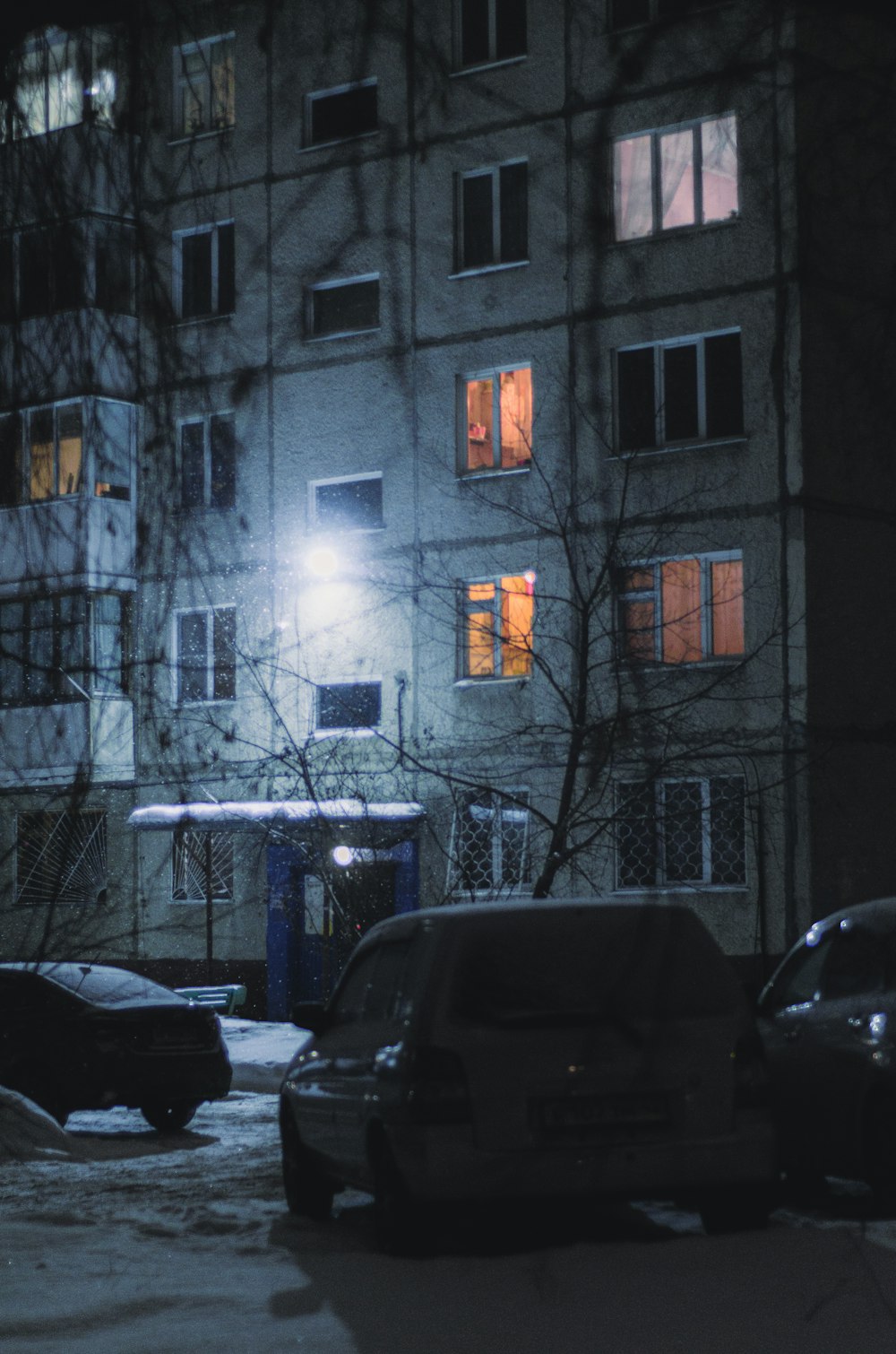 cars parked in front of a building at night