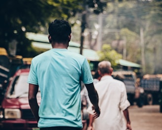 a couple of men walking down a street