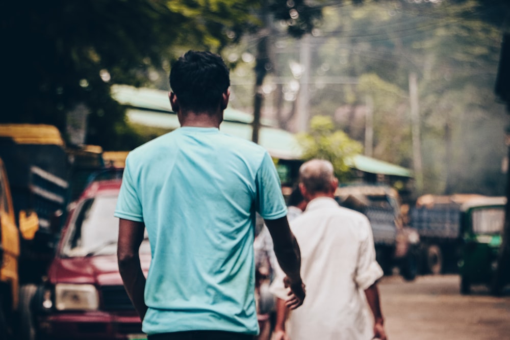 a couple of men walking down a street