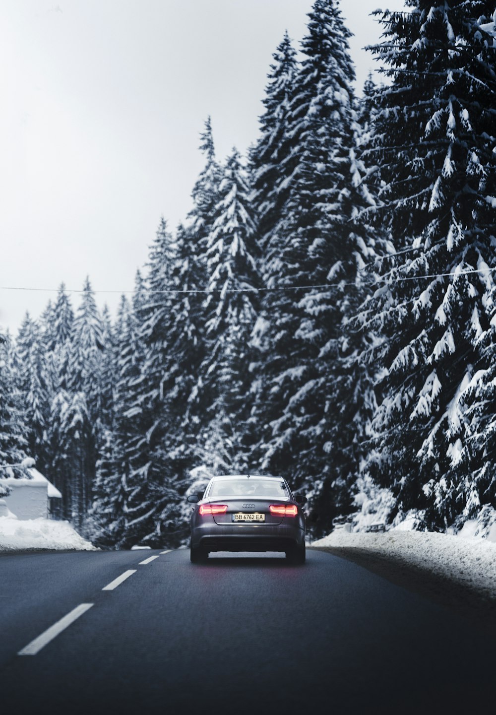 a car is driving down a snowy road