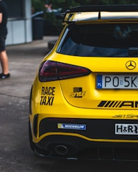 the rear end of a yellow sports car