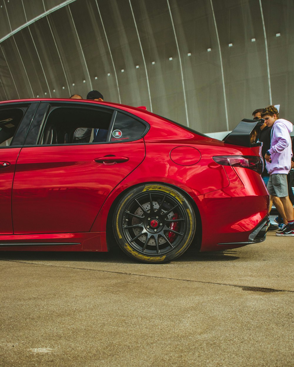 a red car parked in front of a building