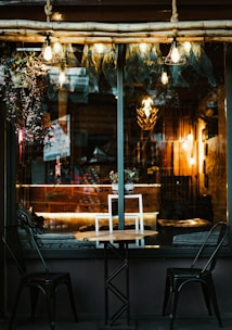 A cozy café table set for two with soft lighting in the evening.