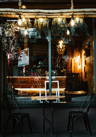 A cozy setting with two friends chatting over coffee, warm light and soft colors.