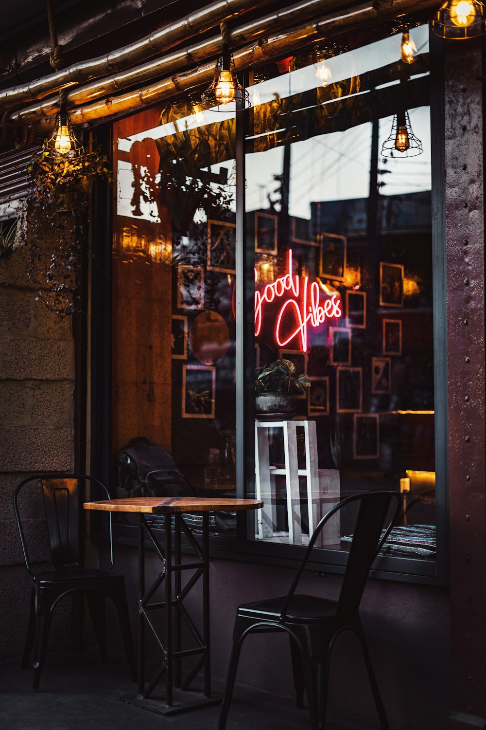 a restaurant with a neon sign in the window