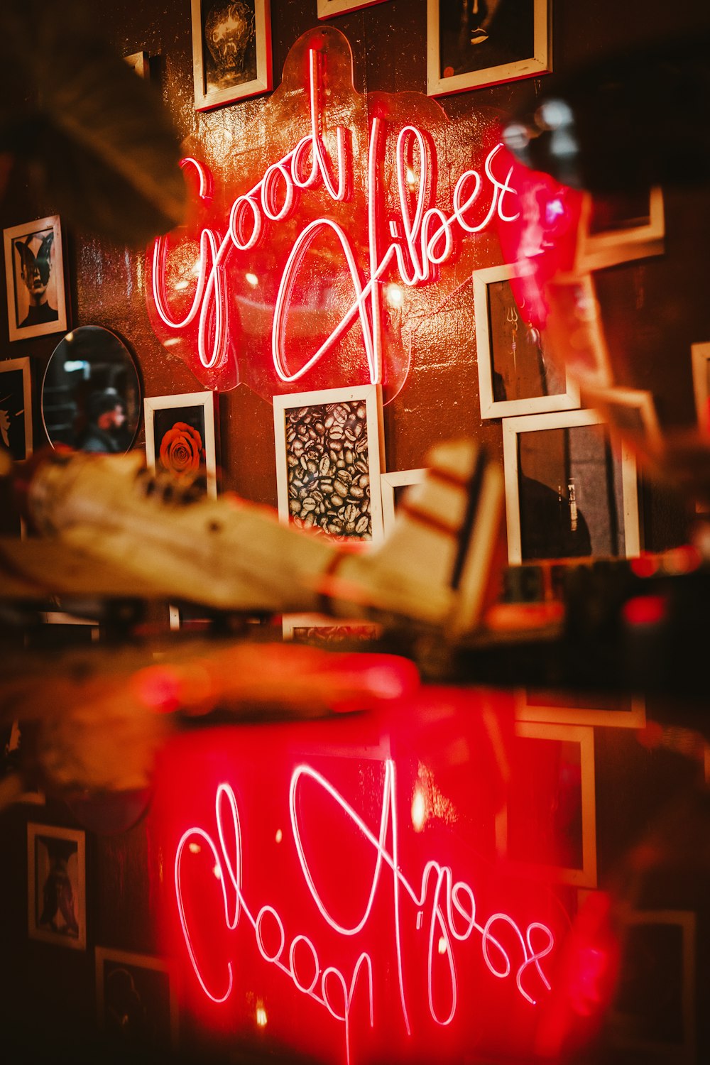 a red neon sign that says good vibes above it
