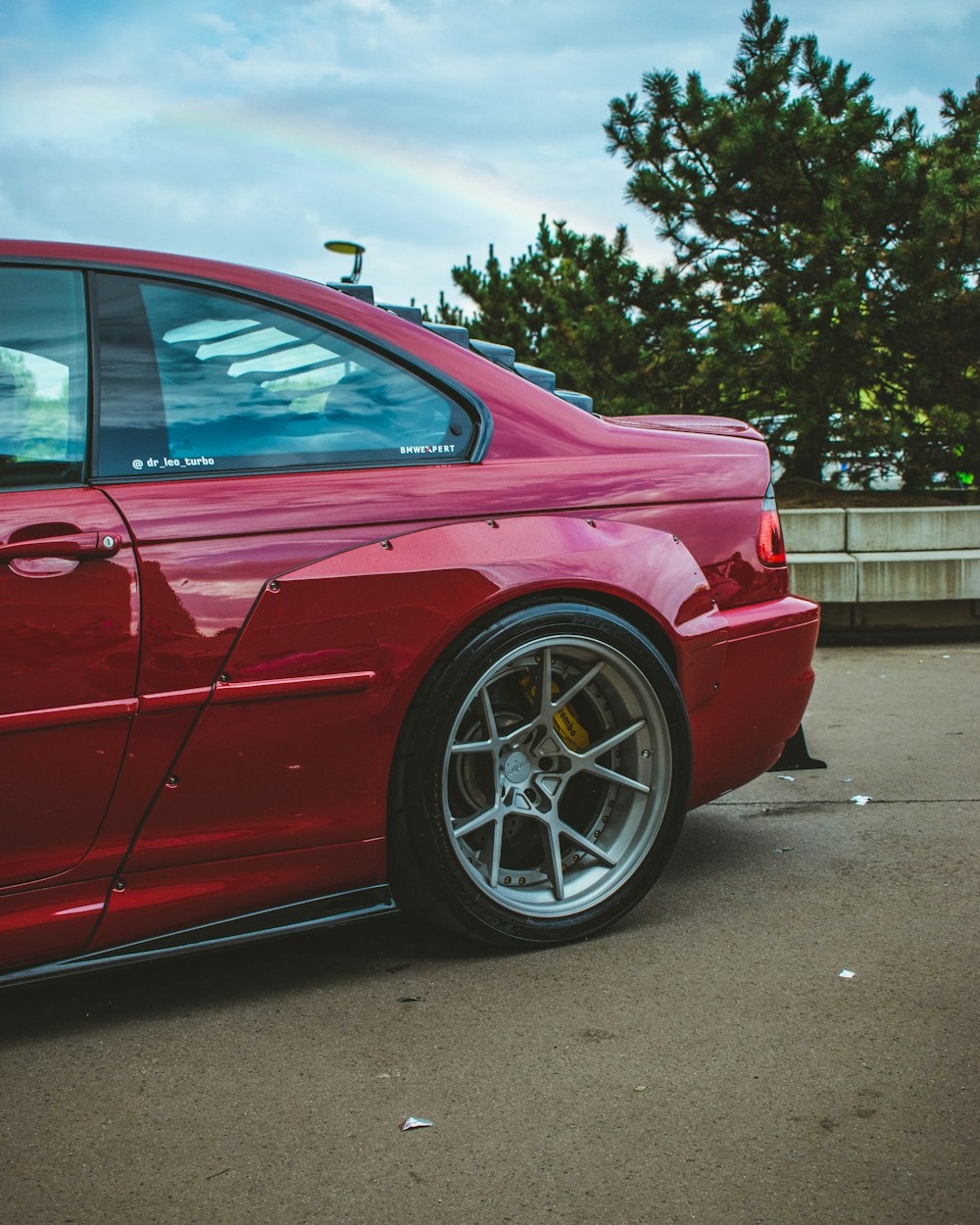 a red sports car parked in a parking lot