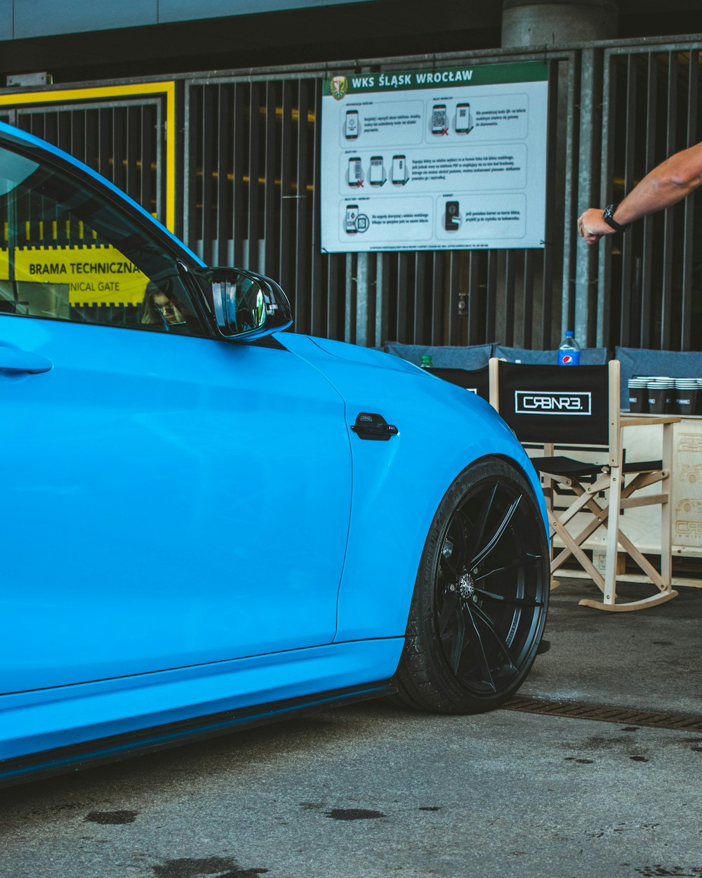 a blue car parked in front of a building