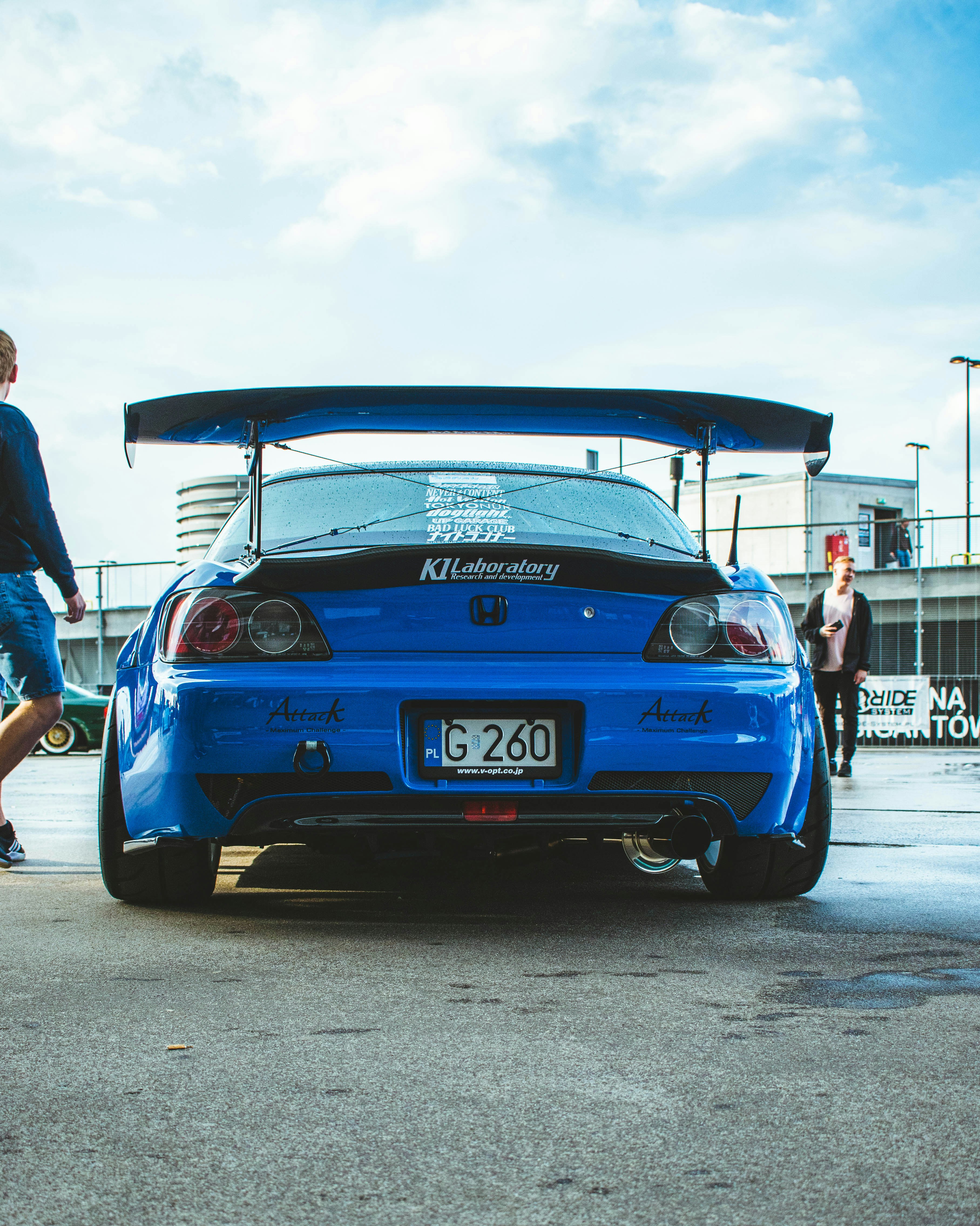 a blue car with a surfboard on top of it