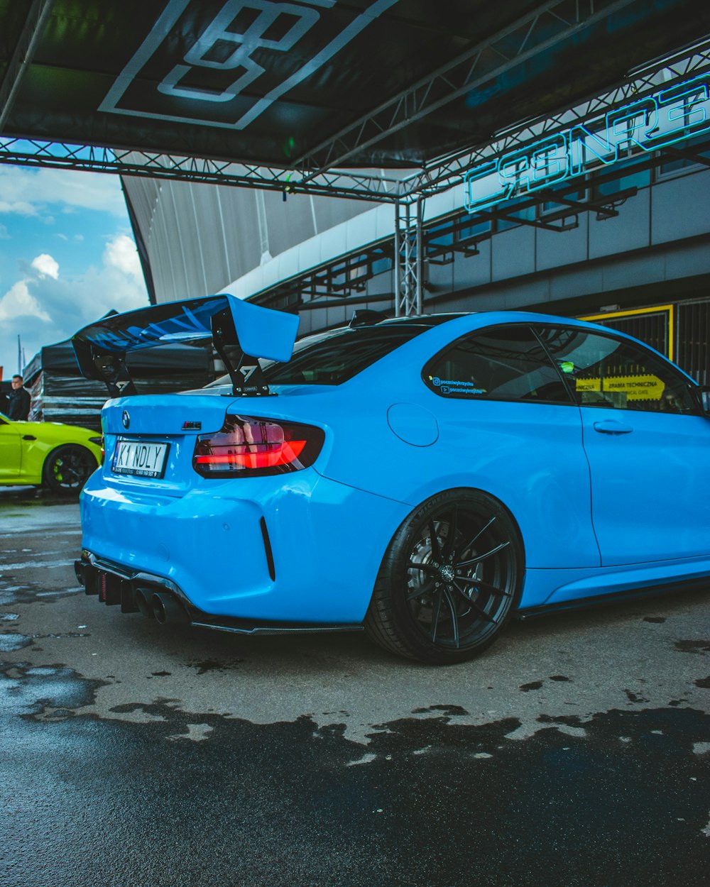 a blue car parked in a parking lot