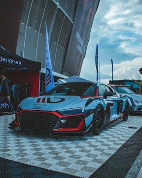 a racing car is parked on a checkered floor