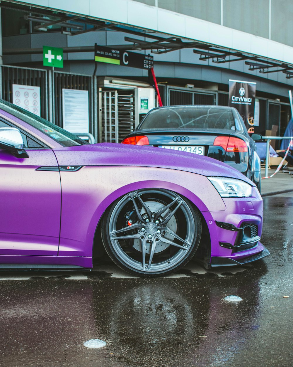 a purple car parked in front of a building