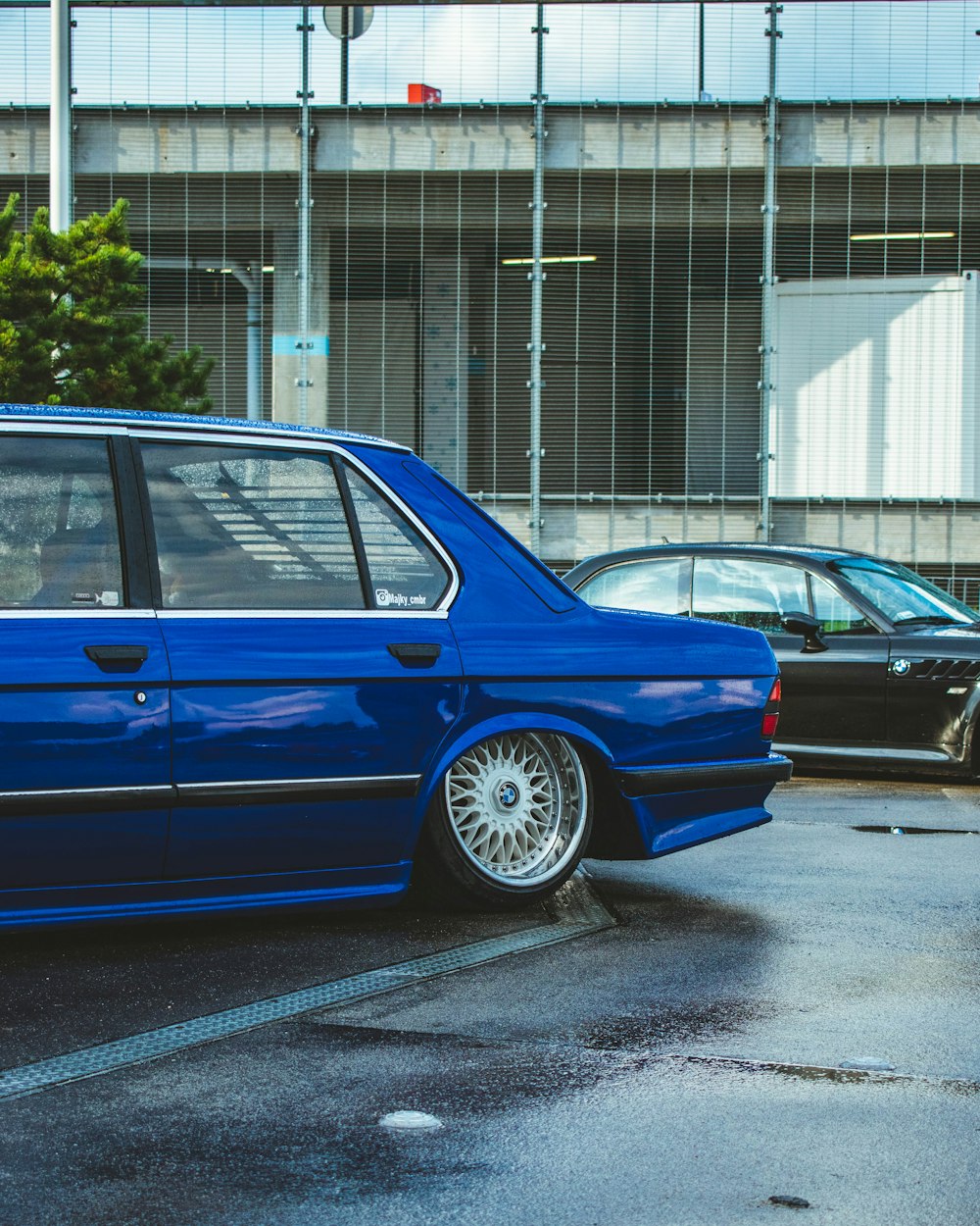 a blue car parked in a parking lot