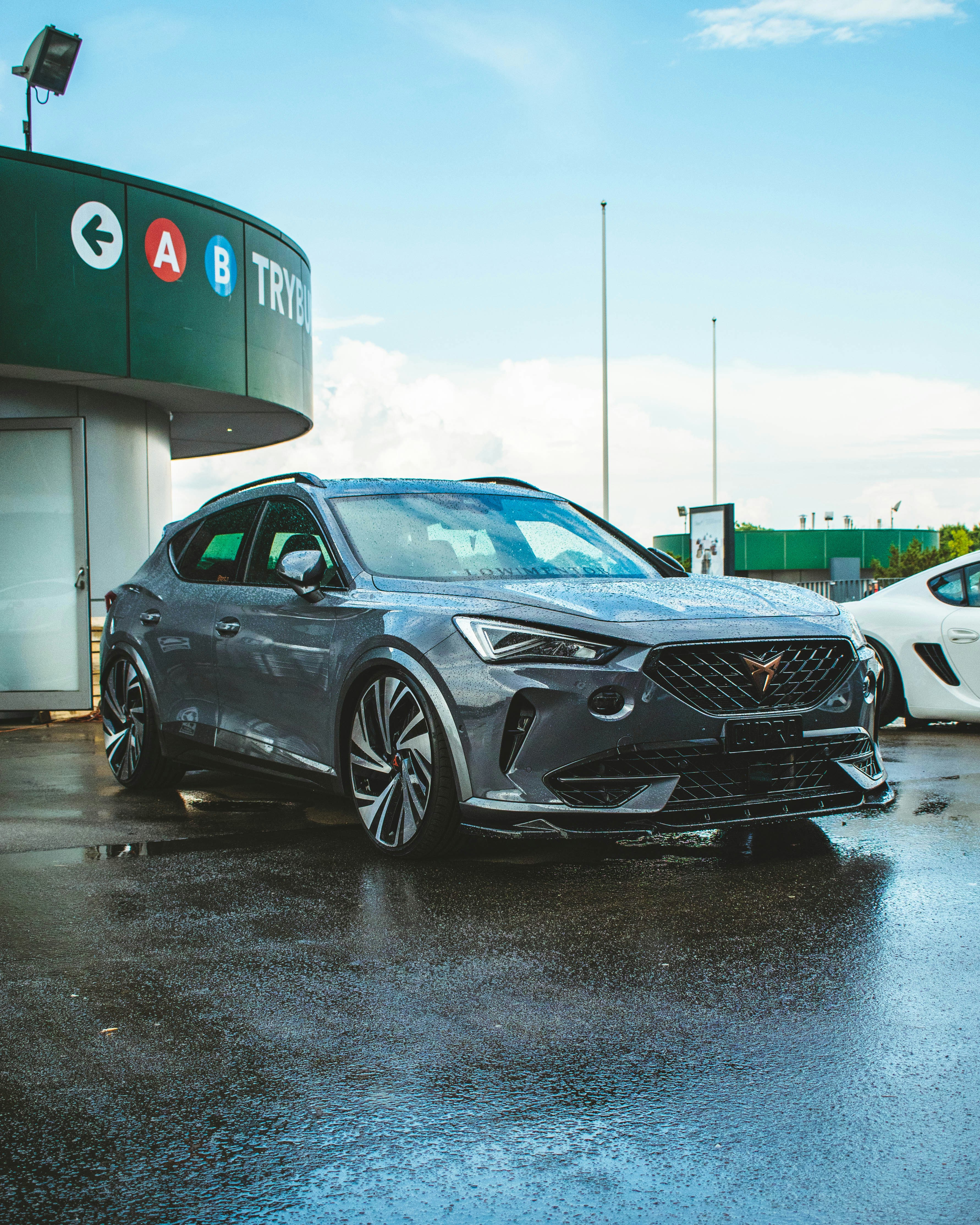 a grey car parked in front of a car wash station