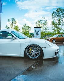 a white sports car parked in a parking lot